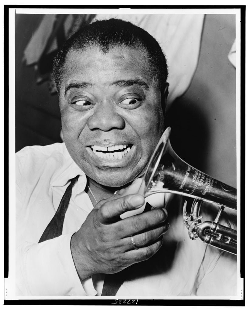 A photograph of Louis Armstrong, holding a trumpet